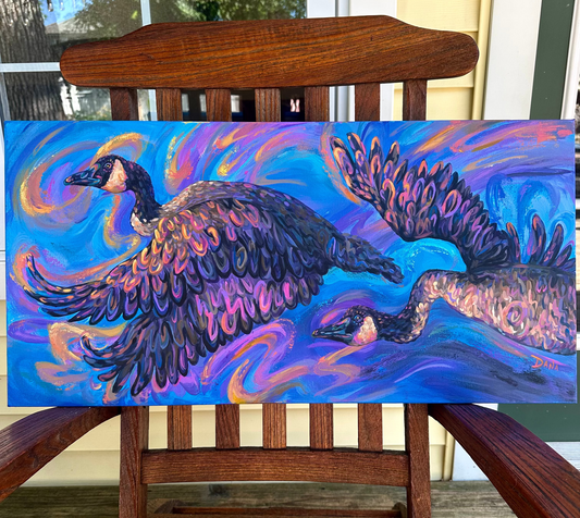 Colorful painting of two geese chasing the sunset. Painting on a wooden chair outdoors